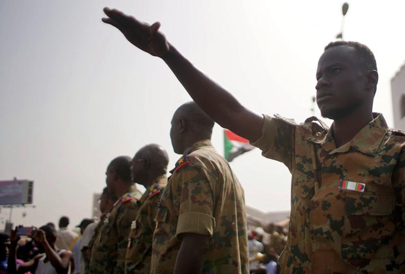 A Sudanese soldier calms the crowds of demonstrators as they attend a protest rally demanding Sudanese President Omar Al-Bashir to step down outside the Defence Ministry in Khartoum, Sudan April 11, 2019. REUTERS