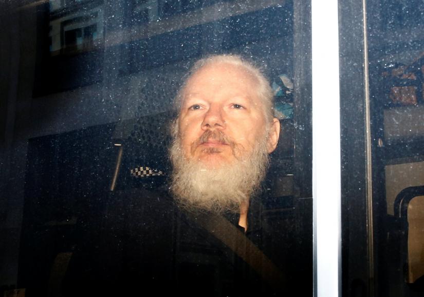 WikiLeaks founder Julian Assange is seen in a police van, after he was arrested by British police, in London, Britain April 11, 2019. REUTERS