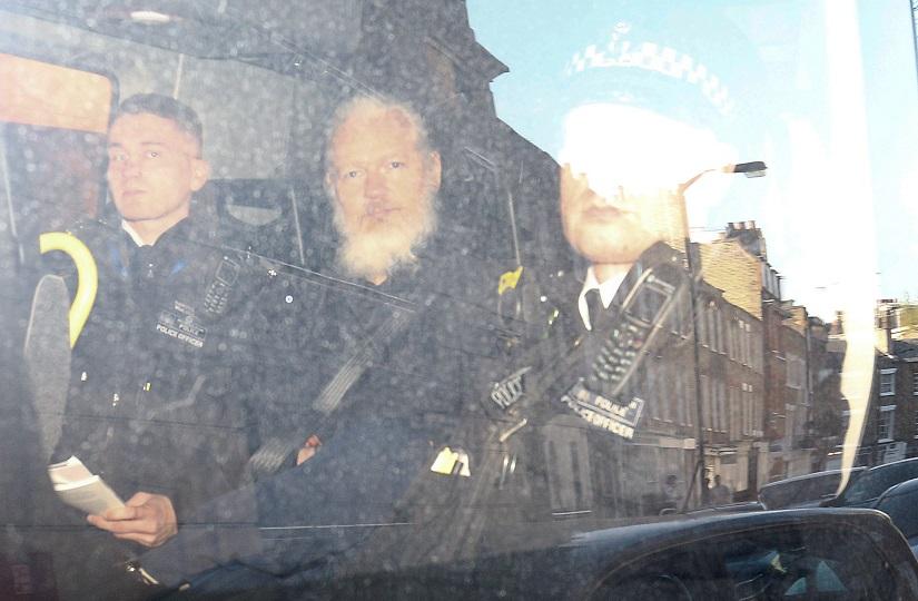 WikiLeaks founder Julian Assange leaves the Westminster Magistrates Court in the police van, after he was arrested in London, Britain April 11, 2019. REUTERS
