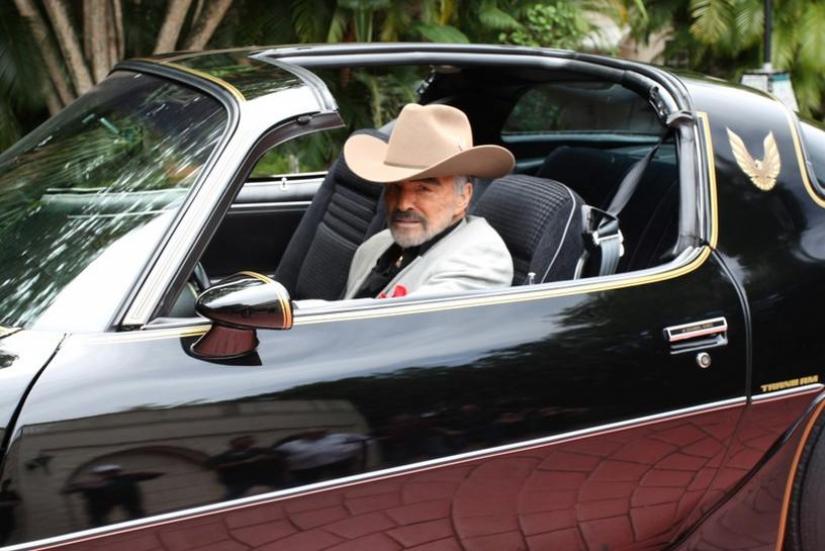 Burt Reynolds sits in a 1979 Pontiac Trans Am, which was the last Trans Am owned and driven by Reynolds, in this Julien`s Auctions photo, released from Culver City, California, U.S., on April 11, 2019. Courtesy Julien`s Auctions/Handout via REUTERS