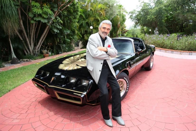 Burt Reynolds stands next to a 1979 Pontiac Trans Am, which was the last Trans Am owned and driven by Reynolds, in this Julien`s Auctions photo, released from Culver City, California, US, on Apr 11, 2019. Courtesy Julien`s Auctions/Handout via REUTERS