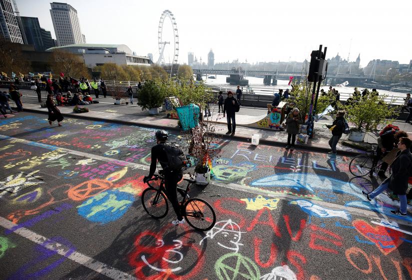 Graffiti is seen on the Waterloo Bridge as climate change activists demonstrate during a Extinction Rebel
