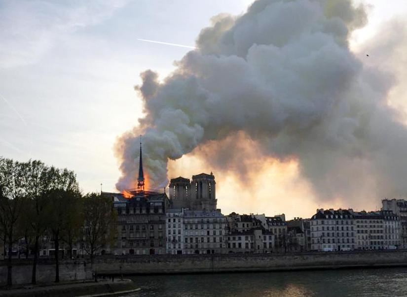 Smoke billows from the Notre Dame Cathedral after a fire broke out, in Paris, France, April 15, 2019. REUTERS