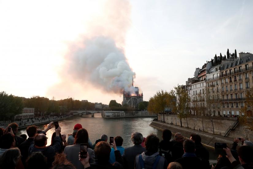 Smoke billows from Notre Dame Cathedral after a fire broke out, in Paris, France April 15, 2019. REUTERS
