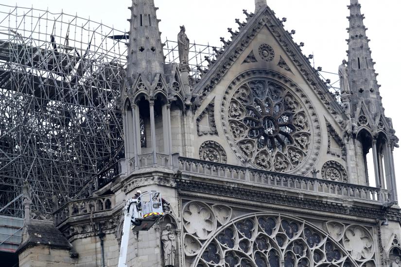 Firefighters work at Notre-Dame Cathedral in Paris, France April 16, 2019. A massive fire consumed the cathedral on Monday, gutting its roof and stunning France and the world. REUTERS