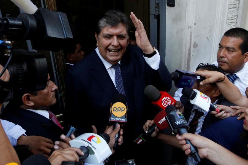 Former Peruvian president Alan Garcia talks to the media as he arrives at the National Prosecution office in Lima, Peru March 27, 2018. REUTERS