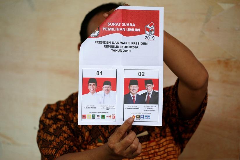 A person holds up a voting ballot during the counting of the Indonesian elections results in Jakarta, Indonesia April 17, 2019. REUTERS