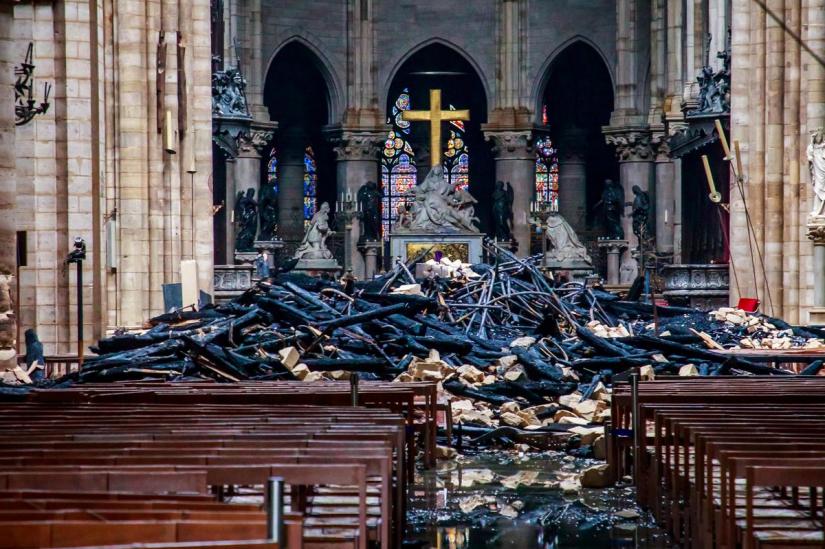 A view of the debris inside Notre-Dame de Paris in the aftermath of a fire that devastated the cathedral, during the visit of French Interior Minister Christophe Castaner (not pictured) in Paris, France, April 16, 2019. Christophe Petit Tesson/Pool via REUTERS