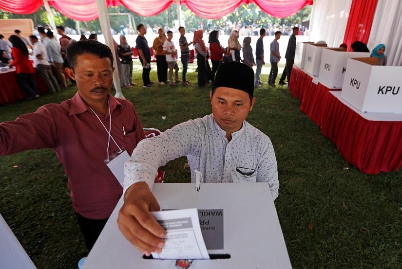 A voter casts his ballot at a polling booth during elections in Bogor, West Java, Indonesia April 17, 2019. REUTERS