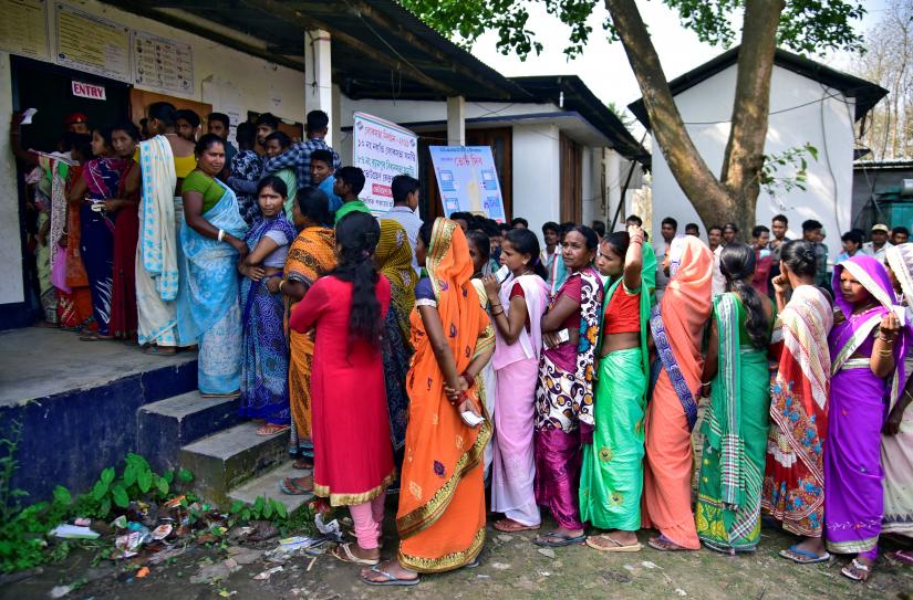 People wait in queues to cast their votes outside a polling station during the second phase of general election in Hojai district in the northeastern state of Assam, India, April 18, 2019