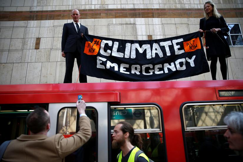 Climate change activists demonstrate during the Extinction Rebellion protest, at Canary Wharf DLR station in London, Britain April 17, 2019. REUTERS
