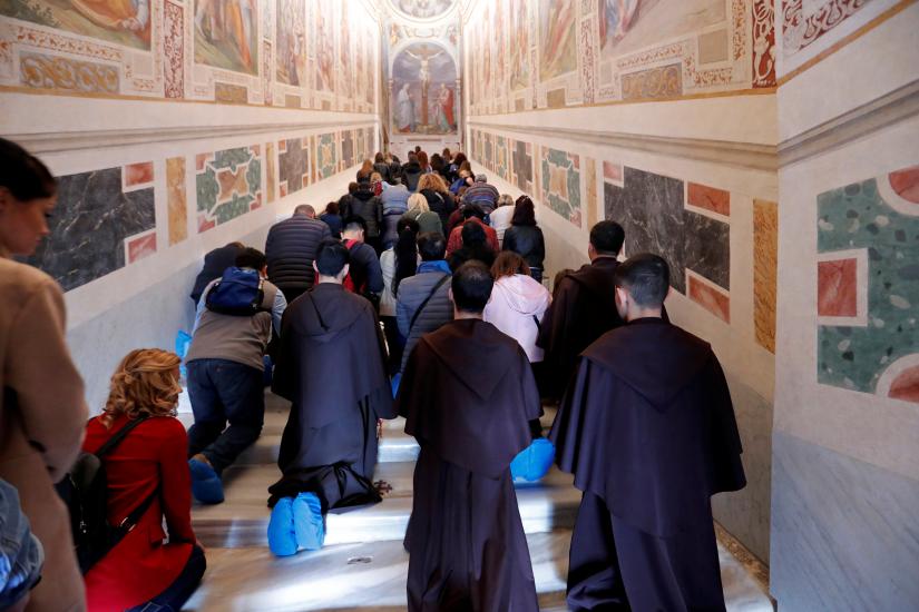 Worshippers pray on the Holy Stairs in Rome, Italy April 16 2019. REUTERS