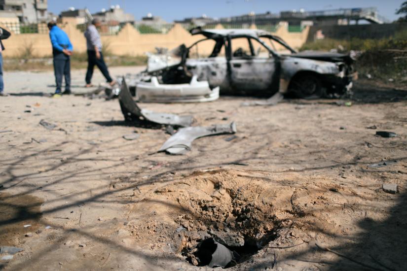 A hole made by exploded missile is seen near a vehicle damaged by an overnight shelling in Abu Salim district in Tripoli, Libya April 17, 2019. REUTERS