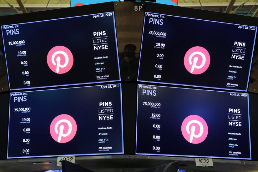 Screens display the company logo and trading information for Pinterest Inc. during the company`s IPO on the front of the New York Stock Exchange