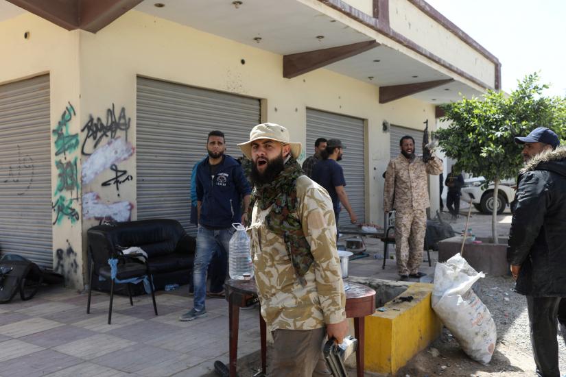 Members of Libyan internationally recognised government forces react during the fighting with Eastern forces at Al-Swani area in Tripoli, Libya April 18, 2019. REUTERS