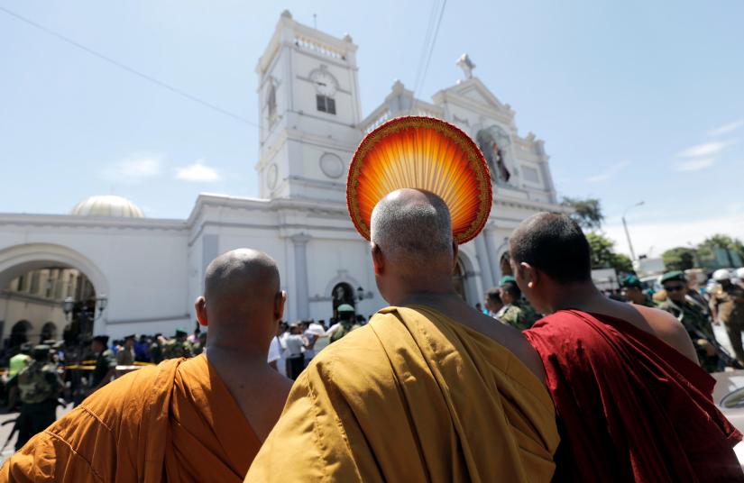 Buddhist monks stand in front of the St. Anthony`s Shrine, Kochchikade church after an explosion in Colombo, Sri Lanka April 21, 2019. REUTERS