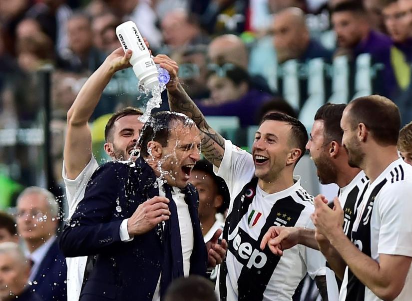 Juventus coach Massimiliano Allegri celebrates winning the league after the match with Federico Bernardeschi and team mates REUTERS