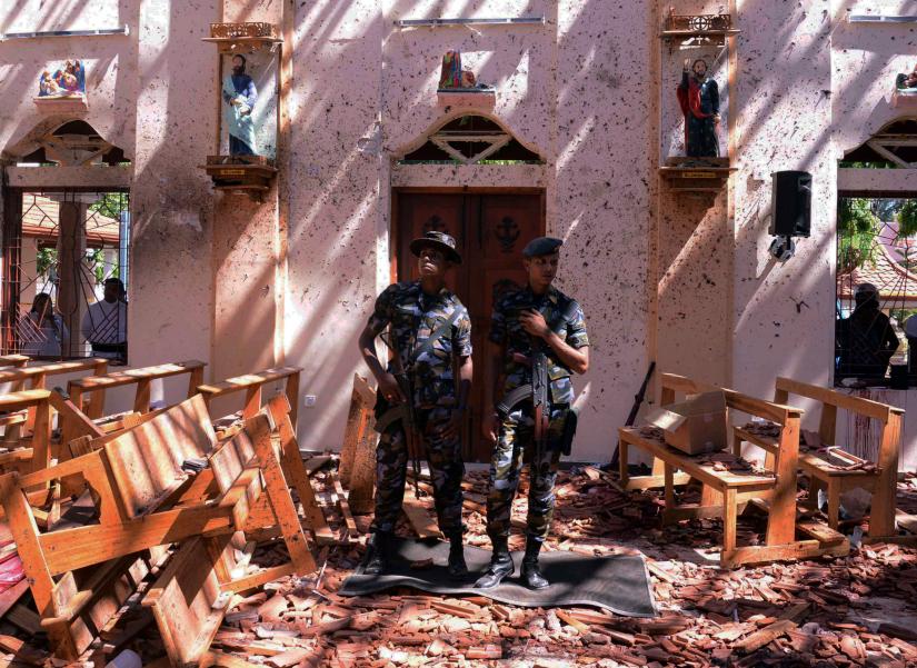 Sri Lankan military stand guard inside a church after an explosion in Negombo, Sri Lanka April 21, 2019. REUTERS