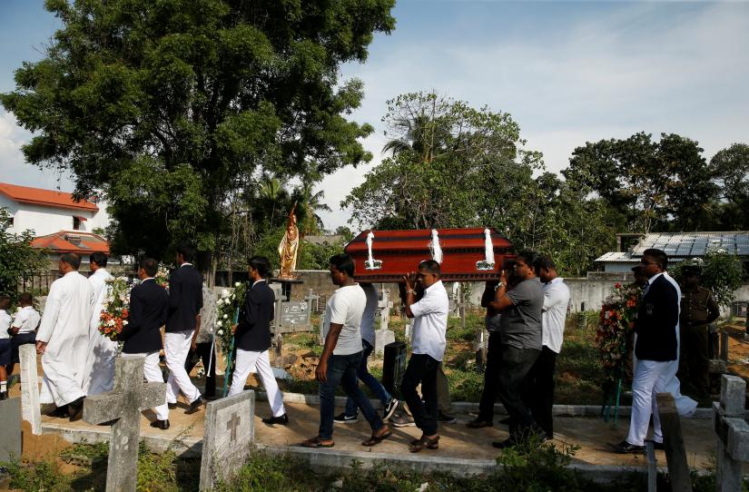 A coffin of a victim is carried, two days after a string of suicide bomb attacks on churches and luxury hotels across the island on Easter Sunday, in Negombo, Sri Lanka April 23, 2019. REUTERS