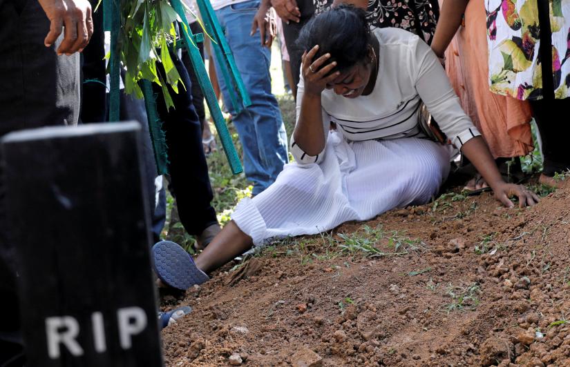 A woman reacts during a mass burial of victims, two days after a string of suicide bomb attacks on churches and luxury hotels across the island on Easter Sunday, in Colombo, Sri Lanka April 23, 2019. REUTERS
