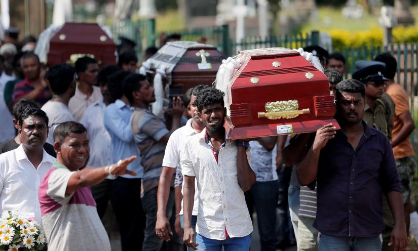 Coffins of victims are carried during a mass for victims, two days after a string of suicide bomb attacks on churches and luxury hotels across the island on Easter Sunday, in Colombo, Sri Lanka April 23, 2019. REUTERS