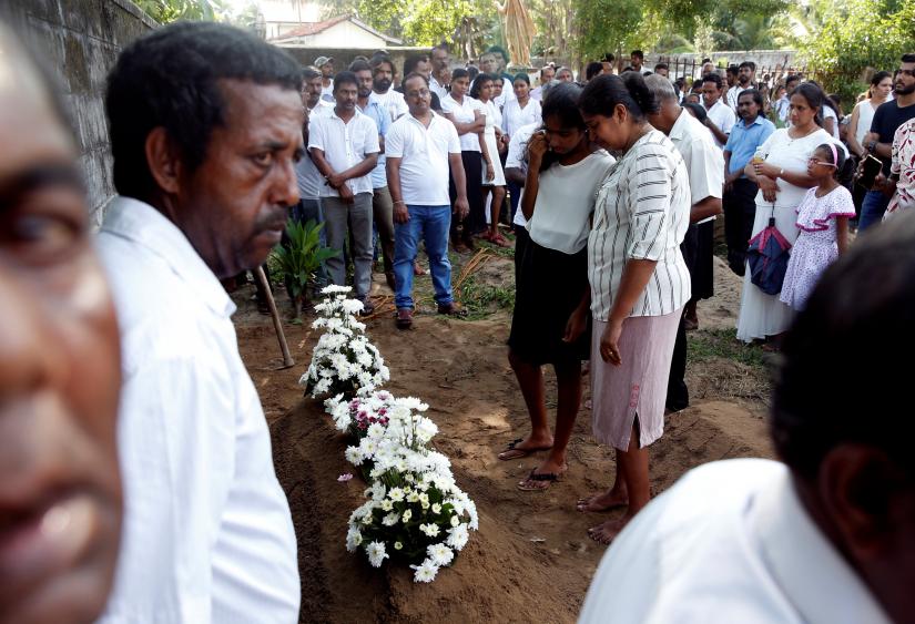 People attend a burial of Vivian Irangani, 67, two days after a string of suicide bomb attacks on churches and luxury hotels across the island on Easter Sunday, in Negombo, Sri Lanka April 23, 2019. REUTERS