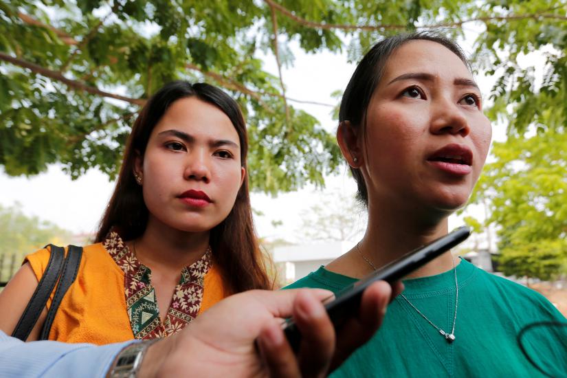 Pan Ei Mon (R) and Chit Su Win, the wives of jailed Reuters reporters Wa Lone and Kyaw Soe Oo speaks to media outside the court in Naypyidaw, Myanmar April 23, 2019. REUTERS
