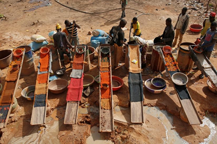 Artisanal miners sluice for gold by pouring water through gravel at an unlicensed mine near the city of Doropo, Ivory Coast, February 13, 2018.