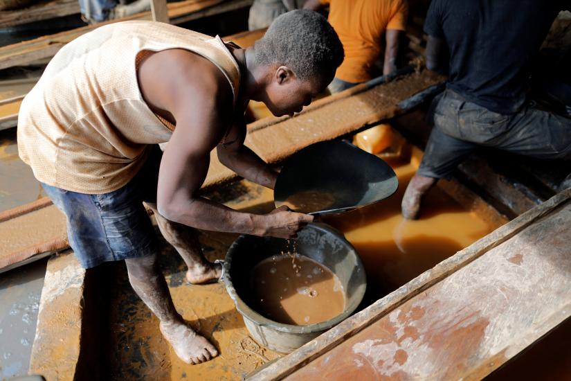 An artisanal miner pans for gold in alluvial sediment over a plastic bucket at the unlicensed mining site of Nsuaem Top in Ghana, November 23, 2018. Picture taken November 23, 2018. REUTERS