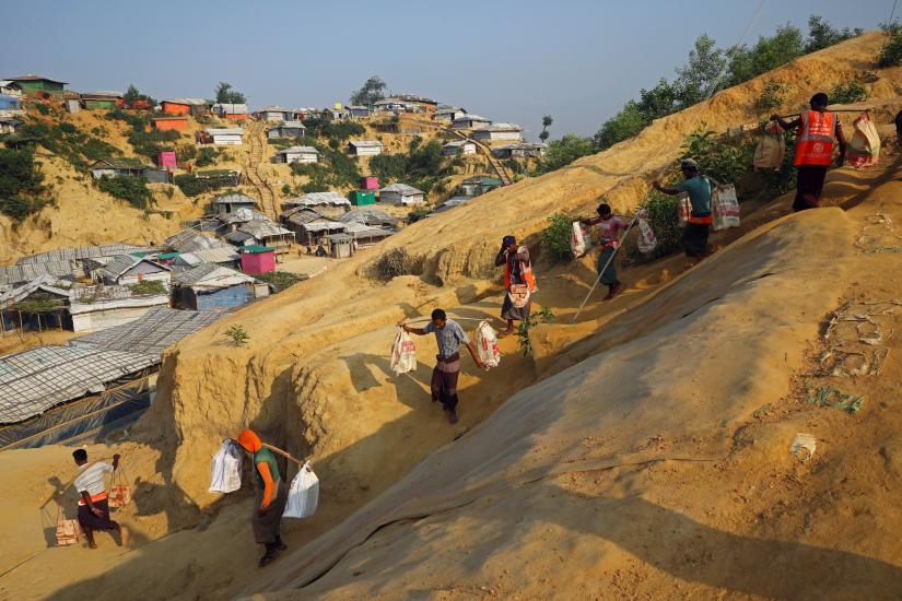 Rohingya refugees carry bricks to a construction site at the Balukhali camp in Cox`s Bazar, Bangladesh, April 8, 2019. REUTERS