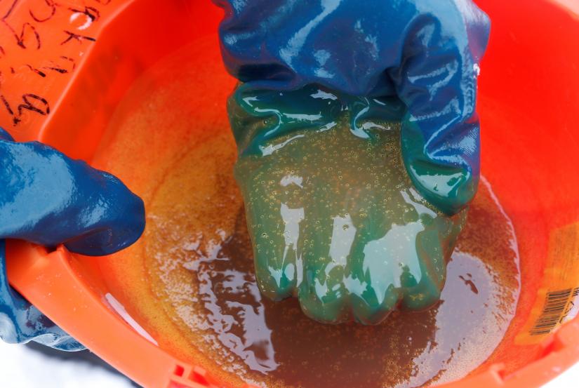 An employee demonstrates a sample of crude oil in the Yarakta Oil Field, owned by Irkutsk Oil Company (INK), in Irkutsk Region, Russia in this picture illustration taken March 10, 2019. Picture taken March 10, 2019. REUTERS