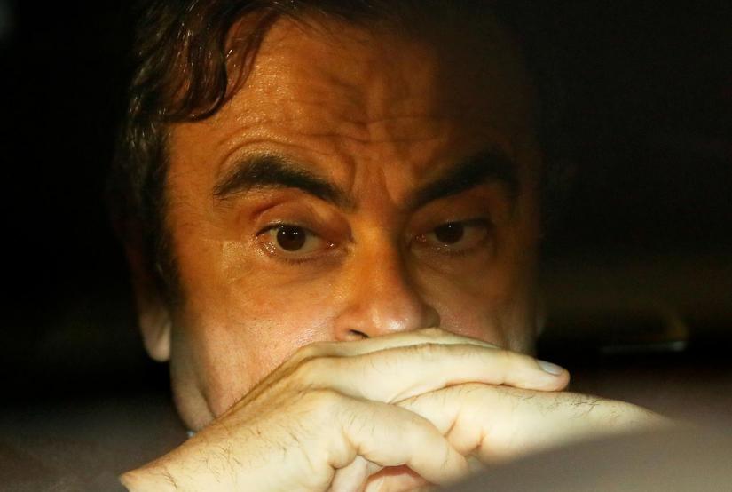 Former Nissan Motor Chairman Carlos Ghosn sits inside a car as he leaves his lawyer`s office after being released on bail from Tokyo Detention House, in Tokyo, Japan, Mar 6, 2019. REUTERS/File Photo