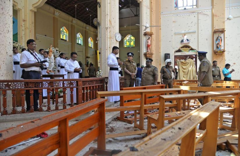 Police officials and catholic priests stand inside the church after a bomb blast in Negombo, Sri Lanka April 21, 2019. REUTERS/File Photo