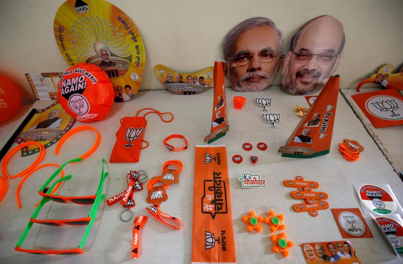 FILE PHOTO: Wristbands, key chains and badges featuring India`s ruling Bharatiya Janata Party (BJP) and masks of the party president Amit Shah and Prime Minister Narendra Modi are on display inside a BJP office ahead of general election in Gandhinagar, Gujarat, India, April 3, 2019. REUTERS