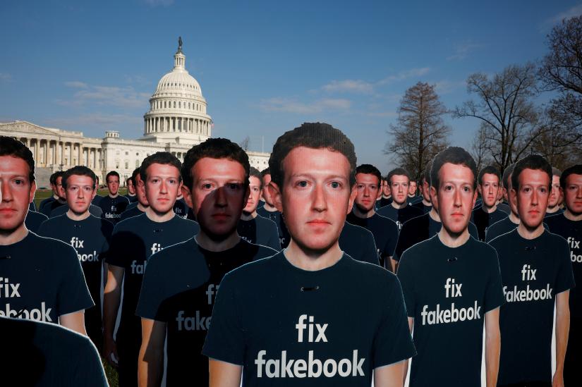 FILE PHOTO: Dozens of cardboard cutouts of Facebook CEO Mark Zuckerberg are seen during an Avaaz.org protest outside the U.S. Capitol in Washington, U.S., April 10, 2018. REUTERS