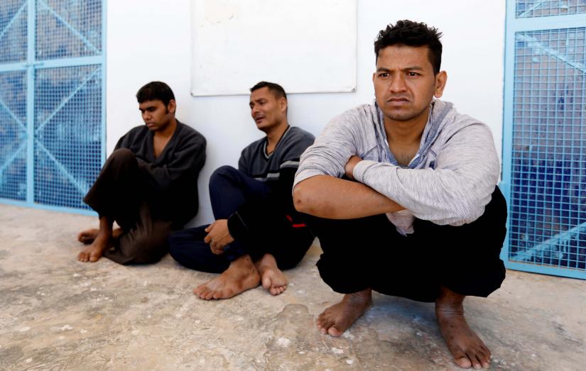 Migrants, who were rescued after their boat capsized in the Mediterranean Sea off the Tunisian Coast after they had left Libya, are seen inside a local Red Cross chapter in Zarzis, Tunisia May 11, 2019. REUTERS