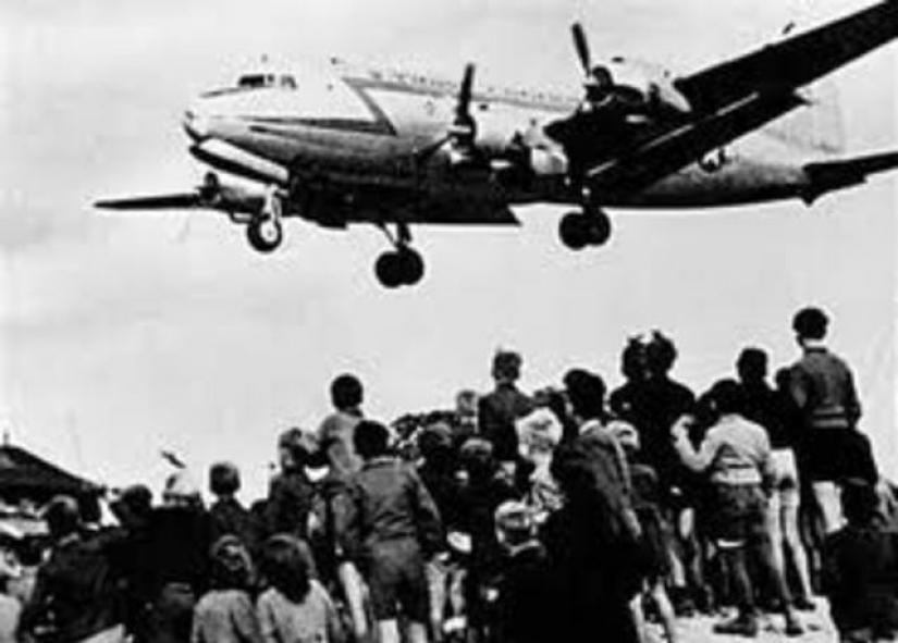 West Berliners watch as a U.S. cargo plane delivers desperately needed supplies during the Berlin Airlift in a photo courtesy of the U.S. Air Force. During the Berlin airlift between 1948 and 1949, Western forces flew hundreds of thousands of tonnes of supplies after the Soviets blocked rail and street access to Berlin`s Western-occupied sectors. REUTERS/U.S. Air Force/Handout
