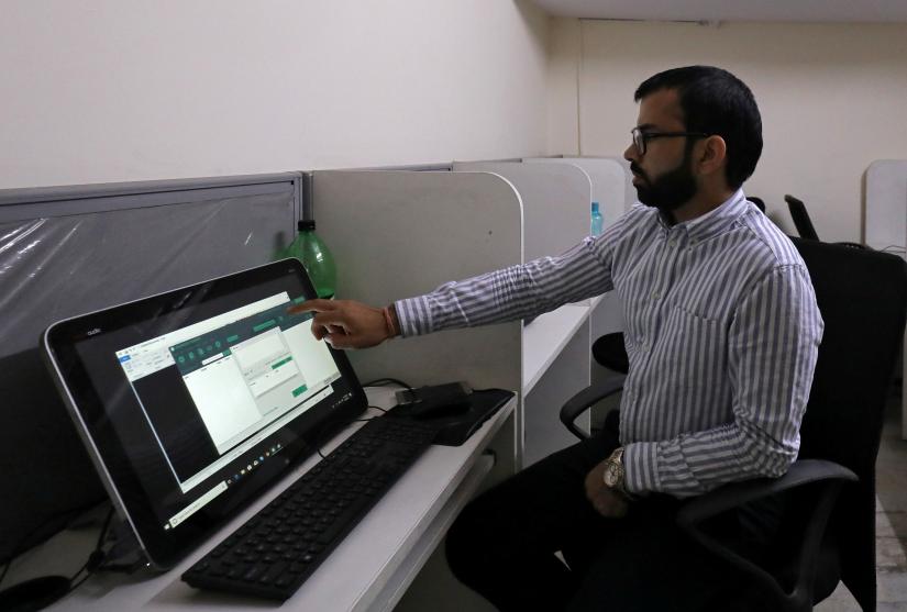 Rohitash Repswal, a digital marketer, shows a software tool that appears to automate the process of sending messages to WhatsApp users, on a screen inside his office in New Delhi, India, May 8, 2019. Picture taken May 8, 2019. REUTERS