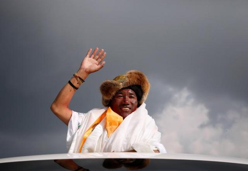 Kami Rita Sherpa, 48, a Nepali Mountaineer waves towards the media personnel upon his arrival after climbing Mount Everest for a 22nd time, creating a new record for the most summits of the worldÕs highest mountain, in Kathmandu, Nepal May 20, 2018. REUTERS