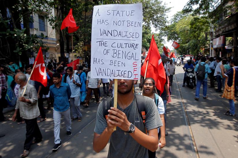 A supporter of the Communist Party of India-Marxist (CPI-M) holds a placard during a protest march after a statue of Ishwar Chandra Vidyasagar, an academic, was damaged during Tuesday`s clashes between supporters of India`s ruling Bharatiya Janata Party (BJP) and the Trinamool Congress, a major regional party, in Kolkata, India May 15, 2019. REUTERS