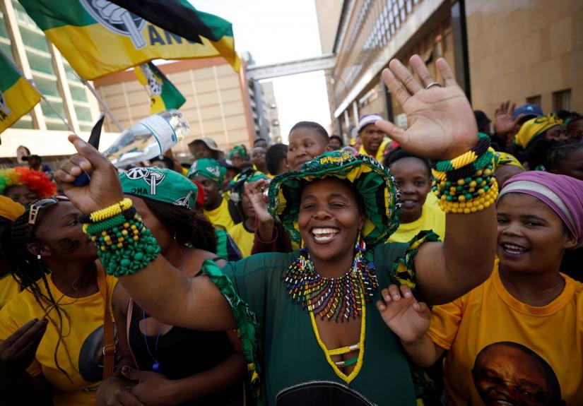 Supporters of the country`s President Cyril Ramaphosa`s ruling African National Congress (ANC) celebrate election results at a rally in Johannesburg, South Africa May 12, 2019. REUTERS