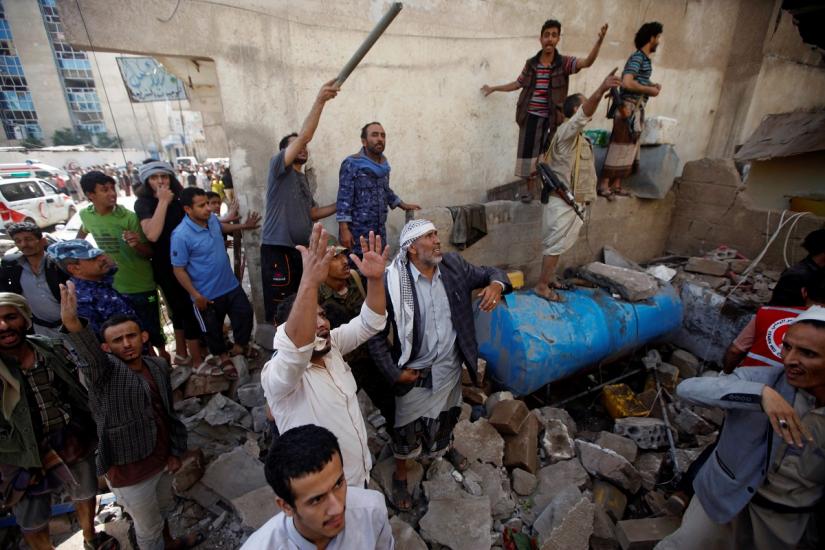 People react at the site of an air strike launched by the Saudi-led coalition in Sanaa, Yemen May 16, 2019. REUTERS