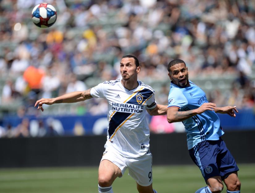 May 11, 2019; Carson, CA, USA; Los Angeles Galaxy forward Zlatan Ibrahimovic (9) plays for the ball against New York City defender Alexander Callens (6) during the second half at StubHub Center. Credit: Gary A. Vasquez-USA TODAY Sports