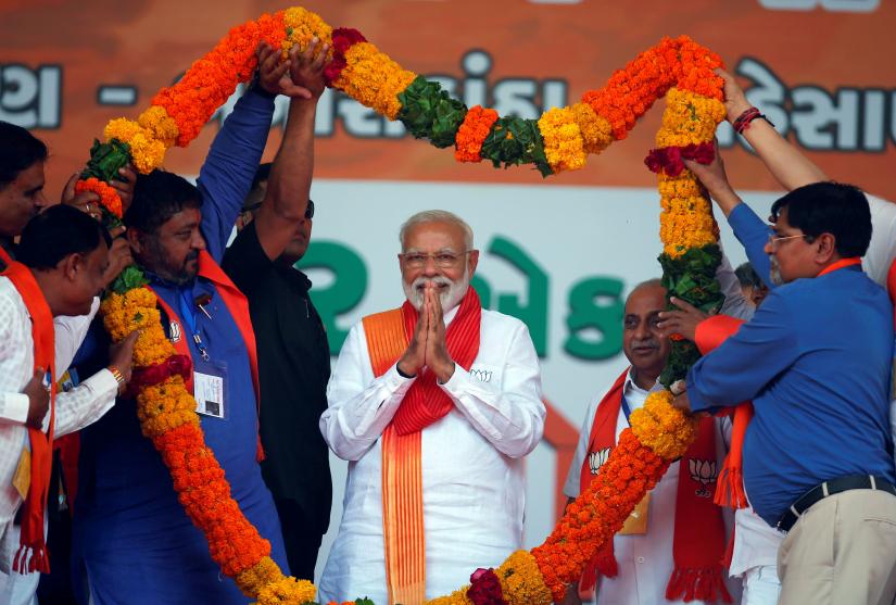 India`s Prime Minister Narendra Modi gestures as he is presented with a garland during an election campaign rally in Patan, Gujarat, India, April 21, 2019. REUTERS