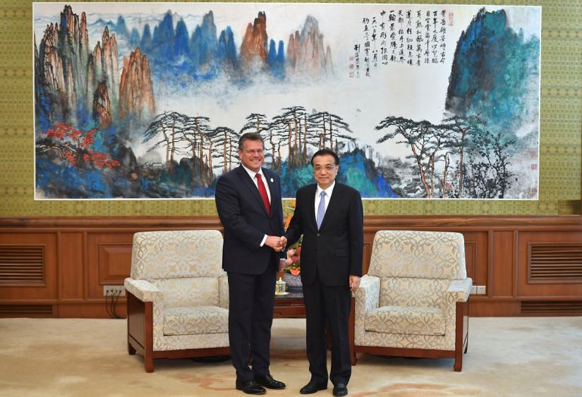 European Commission Vice-President Maros Sefcovic shakes hands with Chinese Premier Li Keqiang as they pose for media before their meeting on April 25, 2019 at the Diaoyutai State Guesthouse in Beijing, China. Parker Song/Pool via REUTERS