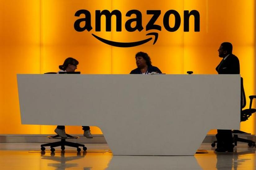 Staff chat at the front desk of the Amazon office in the Manhattan borough of New York, New York, US, May 1, 2019. REUTERS/File Photo