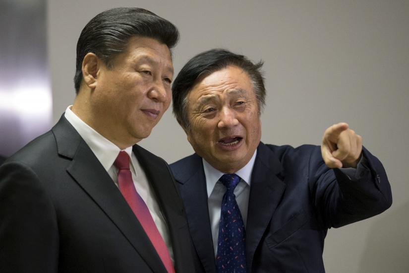 Huawei founder Ren Zhengfei (right) is seen in this October 2015 photo showing around the London offices of Huawei Technologies Co Ltd to Chinese President Xi Jinping (left). REUTERS/file photo