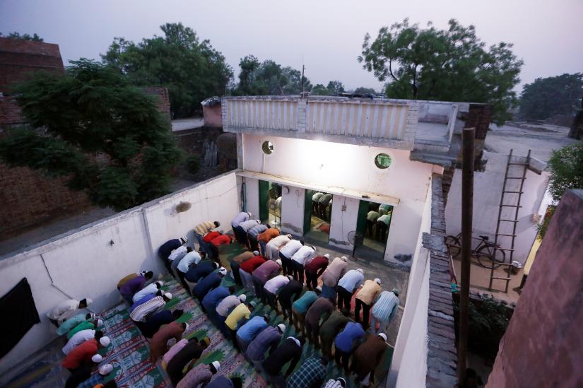 Muslims offer prayer after eating their Iftar (breaking of fast) meal during the holy month of Ramadan inside a madrasa that also acts as a mosque in village Nayabans in the northern state of Uttar Pradesh, India May 9, 2019. Picture taken on May 9, 2019. REUTERS