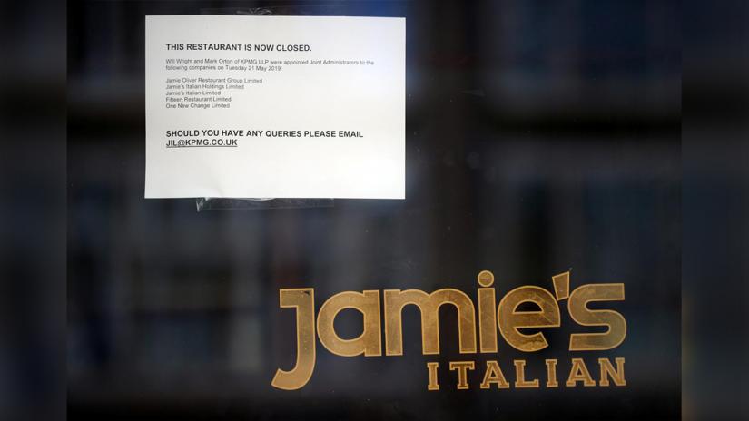A sign informing the closure of a Jamie`s Italian is seen on the door to the restaurant in London, Britain, May 21, 2019. REUTERS