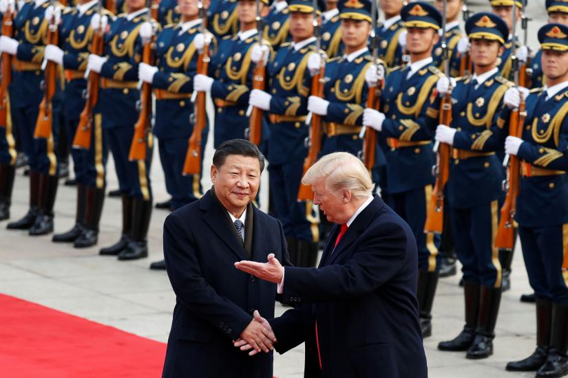 U.S. President Donald Trump takes part in a welcoming ceremony with China’s President Xi Jinping in Beijing in 2017. America’s push to contain Huawei is part of a broader effort to counter China’s expanding military capabilities under Xi. REUTERS